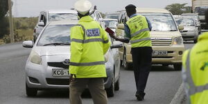 Traffic police officers stop motorist at a checkpoint. On Wednesday, May 13, 2020, NTSA issued a warning to motorists.