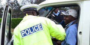 File image of Traffic police inspecting a PSV matatu