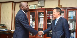 Transport CS Kipchumba Murkomen (left) shaking hands with the Chinese ambassador to Kenya Zhou Pingjian (right) on Wednesday November 16, 2022