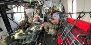 UK Mariner Kevin Nixon receives treatment from US Air Force.