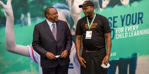 Joe, UK-based Kenyan restaurant owner poses with President Uhuru Kenyatta at the 2021 UK Global Partnership Education Summit
