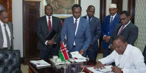 Former President Uhuru Kenyatta and Solicitor General Kennedy Ogeto at a past event at State House.