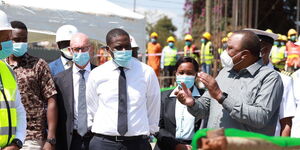 President Uhuru Kenyatta (right) speaks Nairobi Senator Johnson Sakaja (left) during a tour of Nairobi Metropolitan Services's projects in Nairobi's informal settlements on Tuesday, June 30, 2020