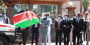 From left: President Uhuru Kenyatta flags of Nairobi Metropolitan Services (NMS) water trucks and ambulances at Harambee House as Nairobi Senator Johnson Sakaja and NMS General Mohamed Badi watch on Tuesday, June 30, 2020