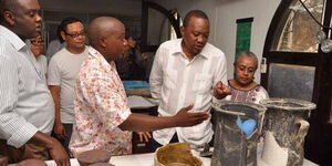 President Uhuru Kenyatta, First Lady Margaret Kenyatta, former Sports and Culture CS Hassan Wario (left), and Head of archaeology NMK Coast Region Ceasar Bita (second left) view artefacts recovered from the shipwrecks on January 3, 2014.