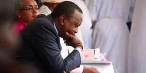 President Uhuru Kenyatta ponders during a service at Apostles of Jesus Shrine Christ, Karen, Nairobi on November 22, 2015.