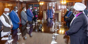 President Uhuru Kenyatta from a distant centre and members of clergy at State House, Nairobi on Thursday, August 18, 2022.