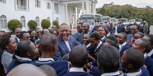 President Uhuru Kenyatta shares a light moment with high school students on August 12, 2016, at State House, Nairobi.