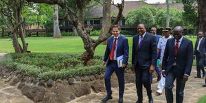 President Uhuru Kenyatta (center) arrives at the official opening of the 6th Global Off-Grid Solar Forum and Expo in Nairobi on Tuesday, February 18.