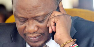 File image of President Uhuru Kenyatta on a phone call