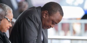Former President Uhuru Kenyatta bows in prayer during a past ceremony 