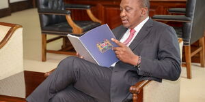 President Uhuru Kenyatta reading proposals contained in the BBI report at State House