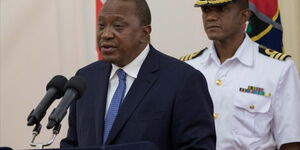 File image of President Uhuru Kenyatta with his personal aide Timothy Lekol