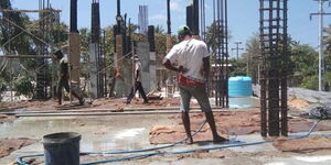 Undated photo of a construction worker at the site during a curing process
