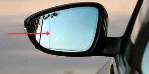 Undated photo of a side mirror of a car with an arrow pointing at a dotted line