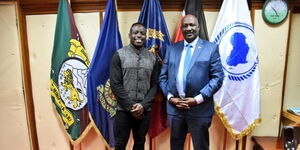 Kenya's sensational sprinter Ferdinand Omanyala poses for a photo with Inspector General of Police Hillary Mutyambai at his Jogoo house office on Friday, December 12.