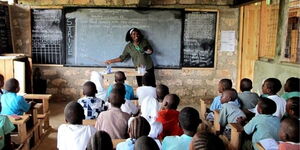 A file image of a teacher with students inside a classroom.