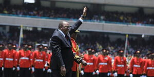Former President Uhuru Kenyatta waving at the crowd after inspecting a guard of honor at Kasarani Stadium on Tuesday, September 13, 2022