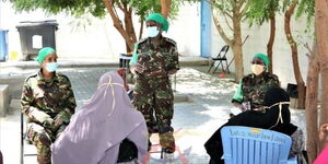 An Image of FET Soldiers Addressing Women in Dhoble, Somalia