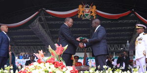 President William Ruto receiving instruments of power from former president Uhuru Kenyatta on Tuesday, September 13, 2022