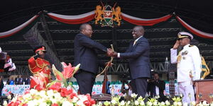 President William Ruto receiving the Sword from former president Uhuru Kenyatta  at Kasarani Stadium on Tuesday, September 13, 2022