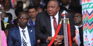 Former President Uhuru Kenyatta listens on as President William Ruto reads his speech at Kasarani Stadium on Tuesday, September 13, 2022