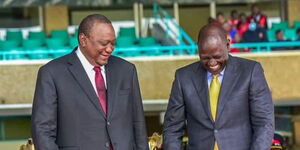 Former President Uhuru Kenyatta sharing a light moment with President William Ruto at Kasarani Stadium on Tuesday, September 13, 2022