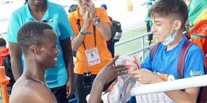 Felix Korir giving his Kenyan jersey to a young boy at the 2022 World Under 20 Athletics Championships in Cali, Colombia.