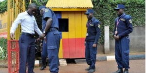 An image of a guard in Kenya inspecting a visitor at the entrance. 