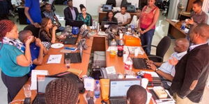 An image of Kenyan workers enjoying a light moment in the office. 