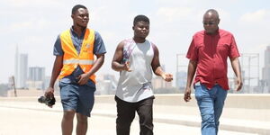 From Left: Unnamed member of Chams Media camera team, Ghanian YouTuber Wode Maya, together with Alex Chamwada on October 23, 2021.