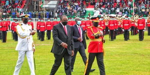 President Uhuru Kenyatta inspects a guard of honour at Wang'uru Stadium in Kirinyaga County on October 20, 2021.