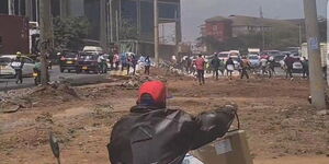 Nairobi residents scramble for flour after a truck overturns along Mombasa Road on September 23, 2022