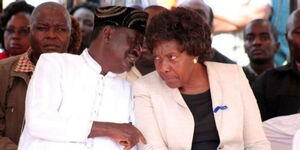 ODM Party leader Raila Odinga whispering to Kitui county governor Charity Ngilu during a past event.