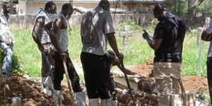 Officials exhume a body in Kitui County.