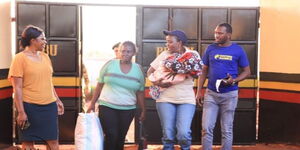 Embu County Woman Representative (holding a baby) walks out of Embu Prison after securing freedom for a lactating woman on November 25, 2022. 