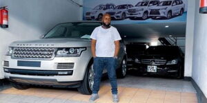 Patrick Mwangi Poses With One of the Vehicles He Sells
