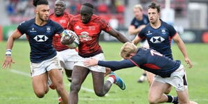 Kenya's wing Tony Onyango (centre) tries to escape a tackle during the 2019 Rugby World Cup Repechage qualifying match between Hong Kong and Kenya at the Delort Stadium, Marseille on November 17, 2018.