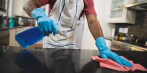 A photo of a cleaner going about their duties