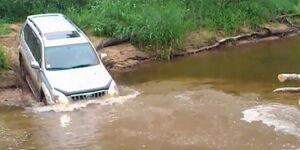 A file image of a vehicle submerged in water.