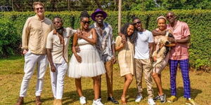 Sauti Sol band members in a group photo with their loved ones