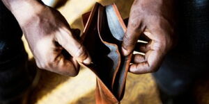 An image of a hand holding an empty wallet. 