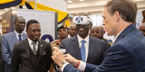 President William Ruto (center) explores some of the innovations exhibited at the Sarit Innovation Expo  on December 6, 2022. Looking on is Sports and Culture Cabinet Secretary Ababu Namwamba. 