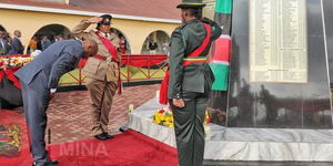 Interior Cabinet Secretary Kindiki Kithure bows in honor of fallen police officers during the memorial ceremony for 53 Police and 4 Prisons officers who have respectively died on duty since November 2021 at the Embakasi Training College. 