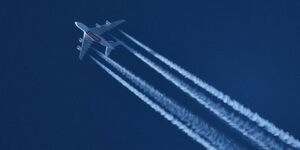 An image of a plane leaving a white trail in its wake.