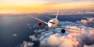 An image of a plane flying above the clouds.