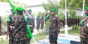 Brigadier William Kamooro (right) honours his predecessor before assuming command of the ATMIS two operation in Somalia on Februaryy 24, 2023.