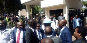 Former Prime Minister Raila Odinga (in a hat) shortly after arriving at the DCI Headqaurters on March 7, 2023. 