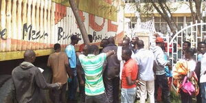 Residents assess the damage caused by the trailer after the accident on March 10, 2023. 