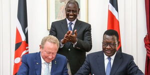 President William Ruto (standing) witnesses the signing of an agreement between Energy CS Davis Chirchir and Fortescue Future Industries
